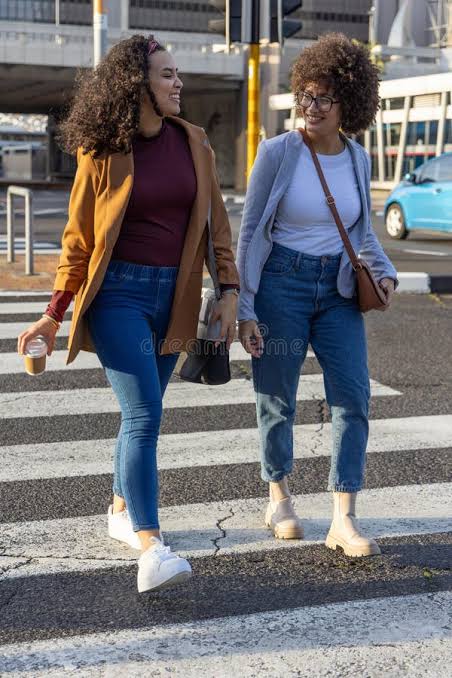 Two women walking together in soft afternoon light